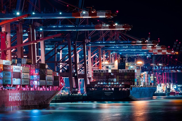 Container port in Felixstowe with large cargo ships and stacked shipping containers at dusk